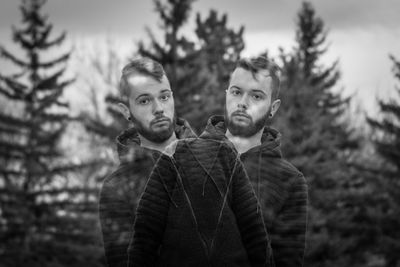 Multiple image of young man standing against trees in forest