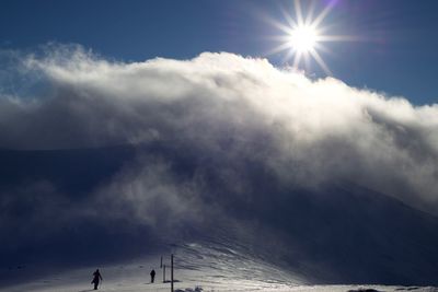 Scenic view of mountains against sky on sunny day