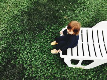 Girl sitting on chair at park