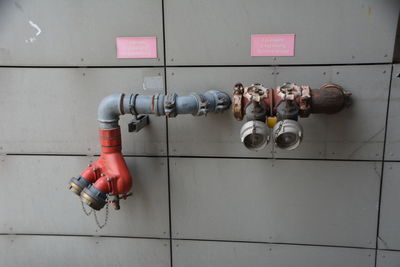 Low angle view of pipes on wall