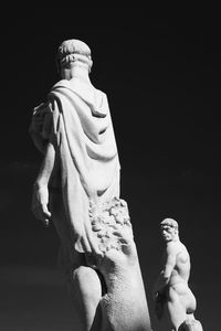 Low angle view of statue against black background
