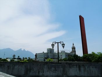 View of factory against cloudy sky