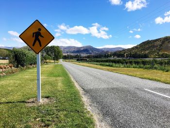 Road sign against sky