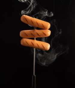 Close-up of orange cake against black background