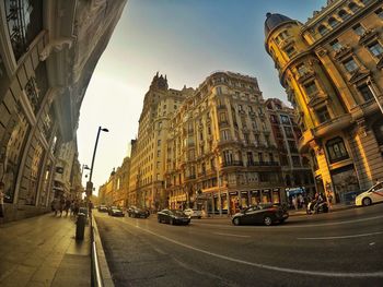 Panoramic view of city street and buildings against sky