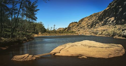 Scenic view of lake against clear blue sky