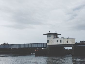 Low angle view of bridge over river against sky