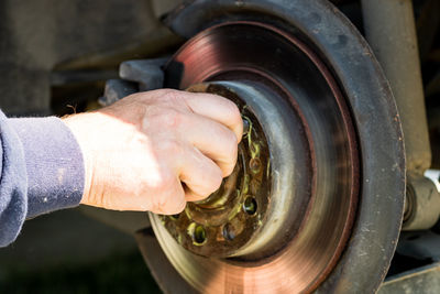 Cropped hand of man repairing vehicle