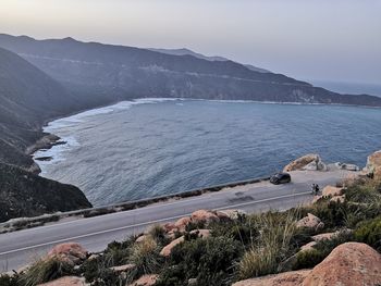 High angle view of sea and mountains against sky