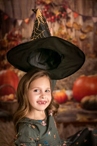 Happy halloween. a beautiful 6-7-year-old girl tries on a witch hat. going to the halloween party. 