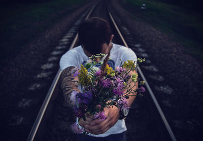 High angle view of man standing with flowers