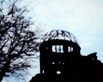 Low angle view of silhouette structure against sky