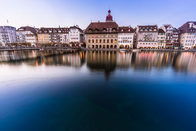 River in town against clear blue sky