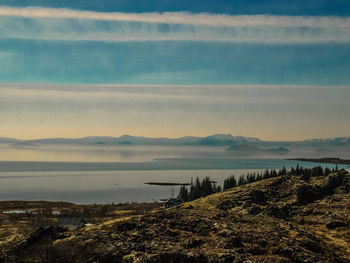 Scenic view of lake and mountains against sky