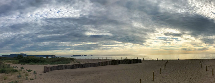 Scenic view of beach against sky during sunset