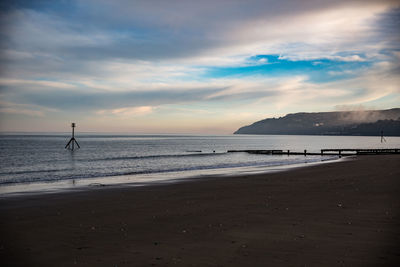 Scenic view of beach against sky during sunset