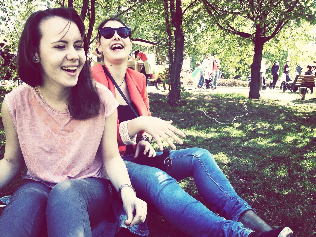 lifestyles, person, leisure activity, young adult, togetherness, smiling, casual clothing, looking at camera, bonding, portrait, happiness, young women, tree, sitting, love, front view, friendship, park - man made space