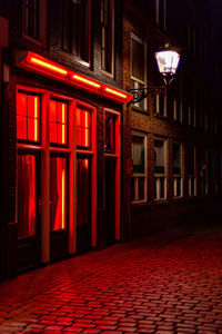 View of red illuminated building at night