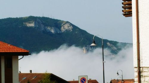 Panoramic view of houses and mountains against clear sky