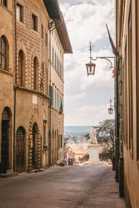 Street amidst buildings against sky