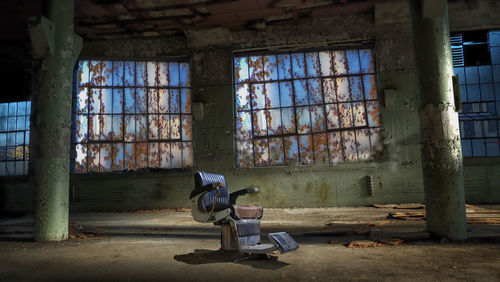 Man sitting in abandoned building