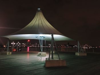 Illuminated built structure against sky at night