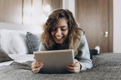 Young woman using laptop at home