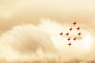 Low angle view of airshow against sky