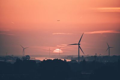 Silhouette of windmill against sky at sunset