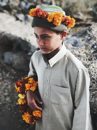 Portrait of young man standing against wall