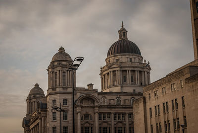 Low angle view of building against cloudy sky