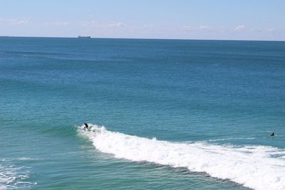 High angle view of person surfing on sea against sky