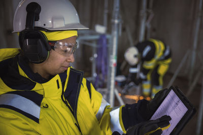 Engineer at building site using digital tablet