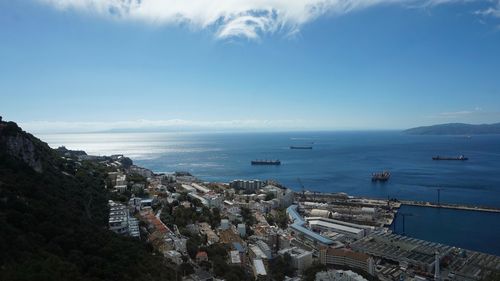 High angle view of sea and cityscape against sky