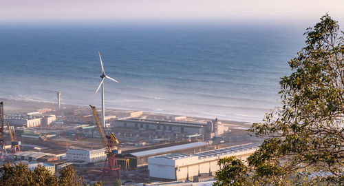 High angle view of buildings and sea against sky