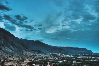 Scenic view of mountains against cloudy sky