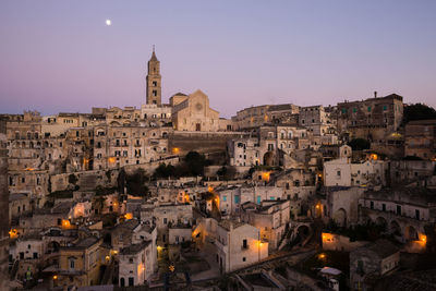 Buildings in city against clear sky