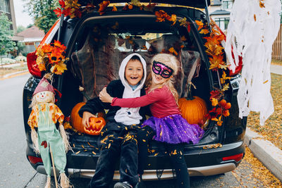 High angle view of girl with toy sitting in car