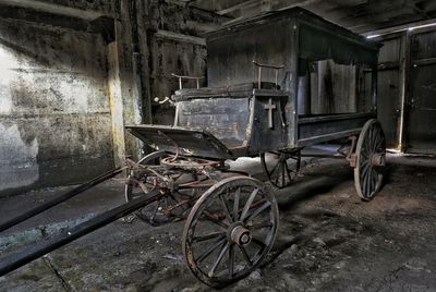 Abandoned vintage car against building