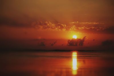 Scenic view of sea against romantic sky at sunset