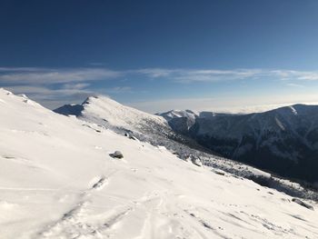 Scenic view of snowcapped mountains against sky