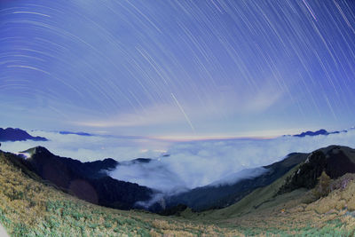 Scenic view of mountains against sky at night