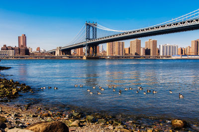 View of bridge over river with city in background