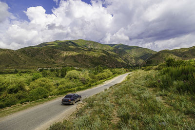 High angle view of road by mountains against sky