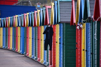 Full length rear view of man walking on multi colored umbrellas