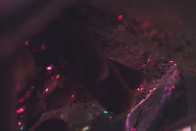 Close-up of woman with pink lights