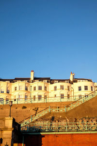 Low angle view of buildings against clear blue sky