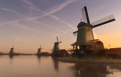 Scenic view of windmills during sunset