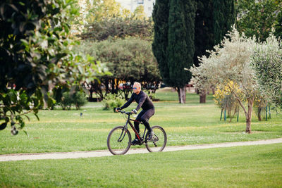 Woman riding bicycle in park