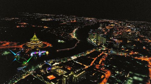 High angle view of city lit up at night